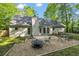 Charming backyard features a cozy gravel firepit area with comfortable seating at 4112 Willow Sw Walk, Lilburn, GA 30047