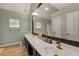 Light-filled bathroom with a double sink vanity, framed mirrors, and attractive fixtures at 4112 Willow Sw Walk, Lilburn, GA 30047