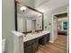 Bright bathroom featuring a double sink vanity, modern fixtures, and laminate floors at 4112 Willow Sw Walk, Lilburn, GA 30047