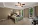 Comfortable bedroom with a ceiling fan, natural lighting, and windows with curtains at 4112 Willow Sw Walk, Lilburn, GA 30047