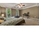 This spacious bedroom offers great natural lighting and has carpeted floors at 4112 Willow Sw Walk, Lilburn, GA 30047