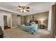 Spacious bedroom with a ceiling fan, decorative crown molding, and carpeted floors at 4112 Willow Sw Walk, Lilburn, GA 30047