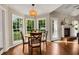 Bright breakfast nook features hardwood floors and windows with backyard views at 4112 Willow Sw Walk, Lilburn, GA 30047