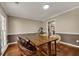 Hardwood floors accent this dining room with natural light and neutral walls at 4112 Willow Sw Walk, Lilburn, GA 30047