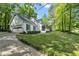Well-maintained home with a two-car garage, tidy landscaping, and a paved driveway at 4112 Willow Sw Walk, Lilburn, GA 30047