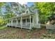 Inviting white home featuring a spacious front porch and a charming picket fence at 4112 Willow Sw Walk, Lilburn, GA 30047