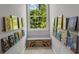 Hallway nook lined with floating bookshelves and a window bench for a charming reading space at 4112 Willow Sw Walk, Lilburn, GA 30047