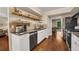 Modern kitchen features updated appliances, cabinets, sink and hardwood floors at 4112 Willow Sw Walk, Lilburn, GA 30047