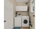 Bright laundry room includes a washer, dryer, storage, and a blue patterned rug at 4112 Willow Sw Walk, Lilburn, GA 30047