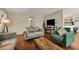 Cozy living room features hardwood floors, neutral walls, and comfortable contemporary furniture at 4112 Willow Sw Walk, Lilburn, GA 30047
