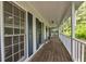 Inviting covered porch with classic white railings and wood flooring at 4112 Willow Sw Walk, Lilburn, GA 30047