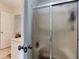 A bathroom featuring a shower with frosted glass doors and tile flooring at 4994 Willow Creek Dr, Woodstock, GA 30188