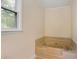 Bathroom featuring large jetted tub beneath window at 4994 Willow Creek Dr, Woodstock, GA 30188