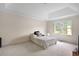 Spacious bedroom with tray ceiling and large window offering outdoor views at 4994 Willow Creek Dr, Woodstock, GA 30188