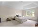 Spacious bedroom with tray ceiling and large window offering outdoor views at 4994 Willow Creek Dr, Woodstock, GA 30188