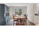 Charming dining room boasting a large wooden table, beautiful china cabinet, and natural light at 4994 Willow Creek Dr, Woodstock, GA 30188