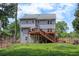 Back exterior showing a spacious deck and lush yard, perfect for outdoor activities and relaxation at 4994 Willow Creek Dr, Woodstock, GA 30188