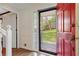 Bright foyer featuring a red front door, hardwood floors, and a view to the front yard at 4994 Willow Creek Dr, Woodstock, GA 30188