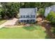 Two-story home boasts a welcoming front porch and well-maintained landscaping at 4994 Willow Creek Dr, Woodstock, GA 30188