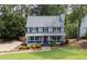 Charming two-story home with a covered front porch and well-manicured lawn at 4994 Willow Creek Dr, Woodstock, GA 30188