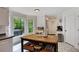 Bright kitchen showcasing an island, white cabinets, stainless appliances, and large window views at 4994 Willow Creek Dr, Woodstock, GA 30188