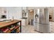 Spacious kitchen with stainless steel refrigerator, white cabinets, and a kitchen island with seating at 4994 Willow Creek Dr, Woodstock, GA 30188