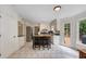 Bright kitchen with an island, white cabinets, stainless steel appliances, and tile flooring at 4994 Willow Creek Dr, Woodstock, GA 30188