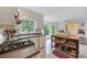 Light-filled kitchen with white cabinets, garden view, stainless appliances, and a kitchen island at 4994 Willow Creek Dr, Woodstock, GA 30188