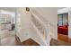 Elegant staircase with white banister and hardwood floors, leading to the upper level at 4994 Willow Creek Dr, Woodstock, GA 30188