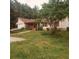 Inviting single-story home featuring a front porch, an attached garage, and a spacious front yard at 6690 Jenkins Rd, Fairburn, GA 30213
