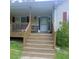 Inviting front porch with steps leading up to the entrance, framed by wooden railings and decorative accents at 6690 Jenkins Rd, Fairburn, GA 30213