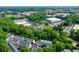 Extensive aerial view captures a community with colorful townhouses surrounded by lush trees at 1346 Peter Haughton Nw Way, Atlanta, GA 30318