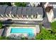 Aerial view of community with the community pool surrounded by mature trees and colorful townhomes at 1346 Peter Haughton Nw Way, Atlanta, GA 30318