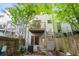View of the private backyard, wooden patio, AC unit, spiraling staircase, and fenced enclosure at 1346 Peter Haughton Nw Way, Atlanta, GA 30318