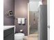 Well-designed bathroom with a shower and a white toilet next to a metal locker storage unit at 1346 Peter Haughton Nw Way, Atlanta, GA 30318