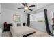 Bright bedroom with a ceiling fan, a modern bed frame, and gray curtains offering natural light at 1346 Peter Haughton Nw Way, Atlanta, GA 30318