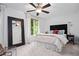 Bright bedroom featuring soft carpet, a dark headboard, and neutral decor at 1346 Peter Haughton Nw Way, Atlanta, GA 30318