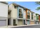 Street-level view of modern townhouses with garages and colorful accents at 1346 Peter Haughton Nw Way, Atlanta, GA 30318