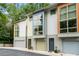 Eye-level of a townhome complex featuring colorful facades and ample green foliage at 1346 Peter Haughton Nw Way, Atlanta, GA 30318