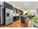 Modern kitchen with dark cabinets, stainless steel appliances, island with seating, and hardwood floors at 1346 Peter Haughton Nw Way, Atlanta, GA 30318