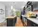 Open concept kitchen features dark cabinets, stainless steel appliances, a butcher block island, and access to patio at 1346 Peter Haughton Nw Way, Atlanta, GA 30318
