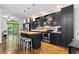 Modern kitchen boasts dark cabinetry, stainless steel appliances, butcher block island, and wood floors at 1346 Peter Haughton Nw Way, Atlanta, GA 30318