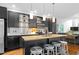 Eat-in kitchen features dark cabinets, stainless steel appliances, an island with seating, and wood floors at 1346 Peter Haughton Nw Way, Atlanta, GA 30318