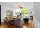 Bright living room with hardwood floors, comfortable seating, ceiling fan, and large windows at 1346 Peter Haughton Nw Way, Atlanta, GA 30318