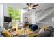 Spacious living room featuring a ceiling fan, large windows, and comfortable seating area at 1346 Peter Haughton Nw Way, Atlanta, GA 30318