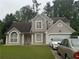 Charming two-story home featuring a well-manicured lawn, neutral stucco, and an attached two-car garage at 3393 Chancellors Dr, Powder Springs, GA 30127