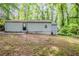 The home features a spacious backyard with mature trees, perfect for outdoor activities at 3735 Boulder Park Sw Dr, Atlanta, GA 30331
