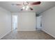 Cozy bedroom with ceiling fan, neutral walls, and a doorway to the bathroom at 3735 Boulder Park Sw Dr, Atlanta, GA 30331