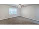 Comfortable bedroom with plush carpet, neutral walls, large window and ceiling fan at 3735 Boulder Park Sw Dr, Atlanta, GA 30331