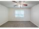 Relaxing bedroom with a ceiling fan, large window, neutral walls, and plush carpet at 3735 Boulder Park Sw Dr, Atlanta, GA 30331